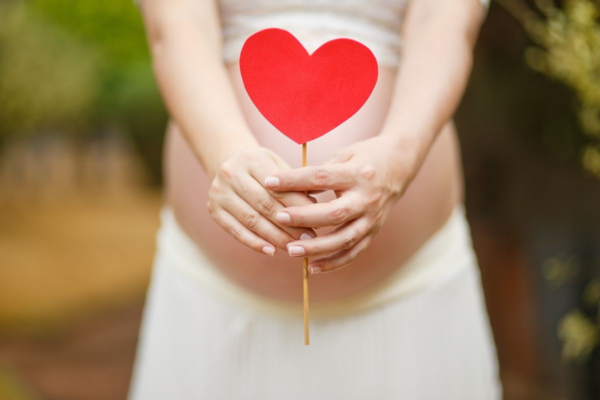 Pregnant woman organizing baby items on a budget