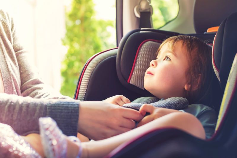 Certified Child Passenger Safety Technician inspecting car seat installation