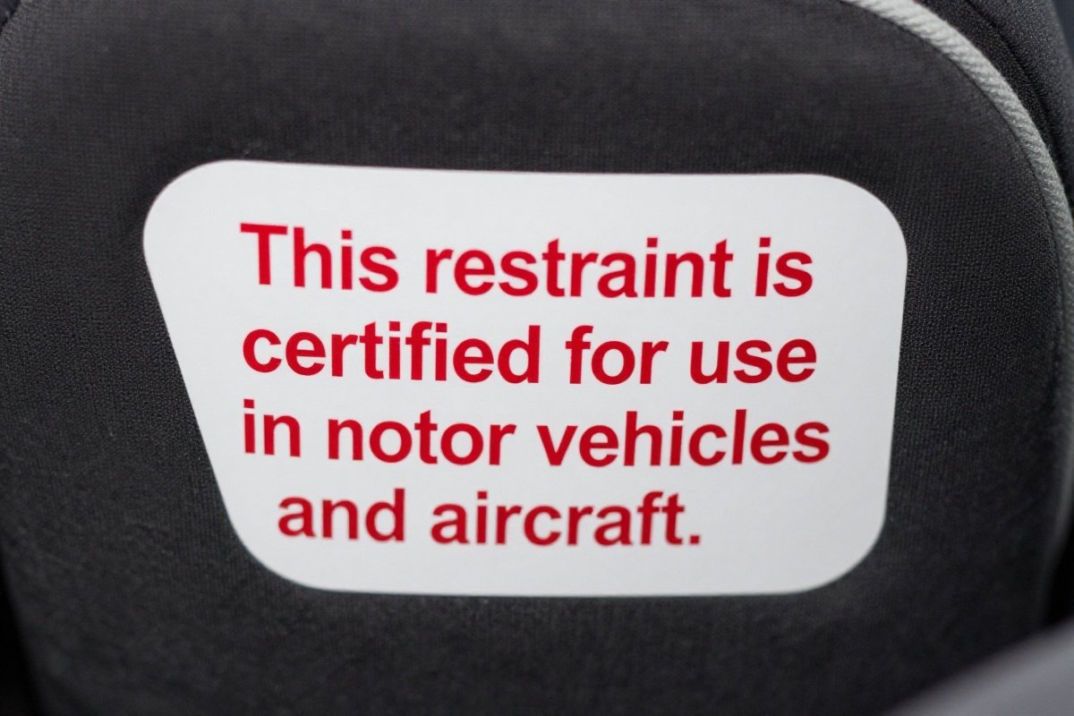 FAA certification label on car seat confirming approval for aircraft use