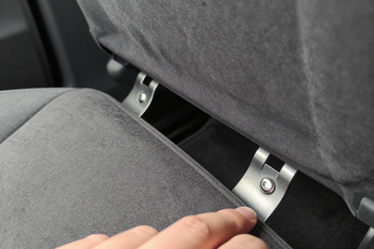 Finger revealing U-shaped LATCH anchor bars in vehicle seat crease