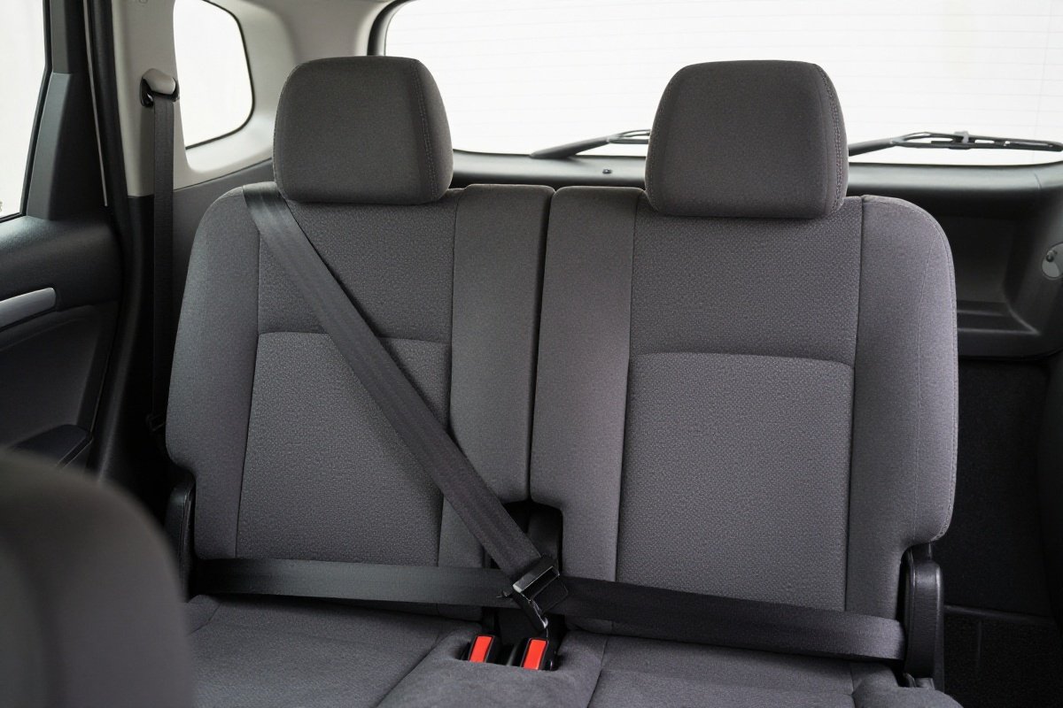 Front passenger seat pushed fully back from dashboard showing maximum safety distance