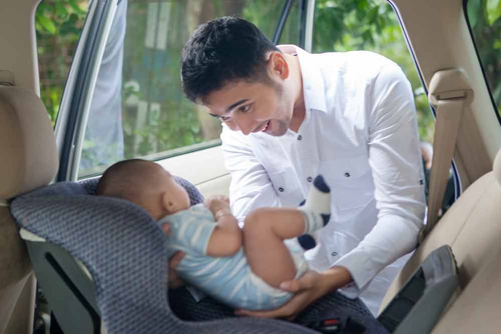 Child in extended rear-facing car seat showing proper positioning