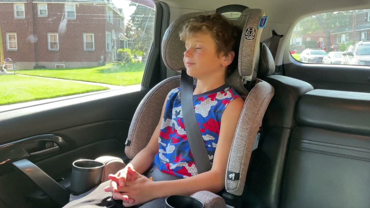 Child sleeping in Graco 4Ever DLX Grad 5-in-1 car seat in booster mode inside vehicle