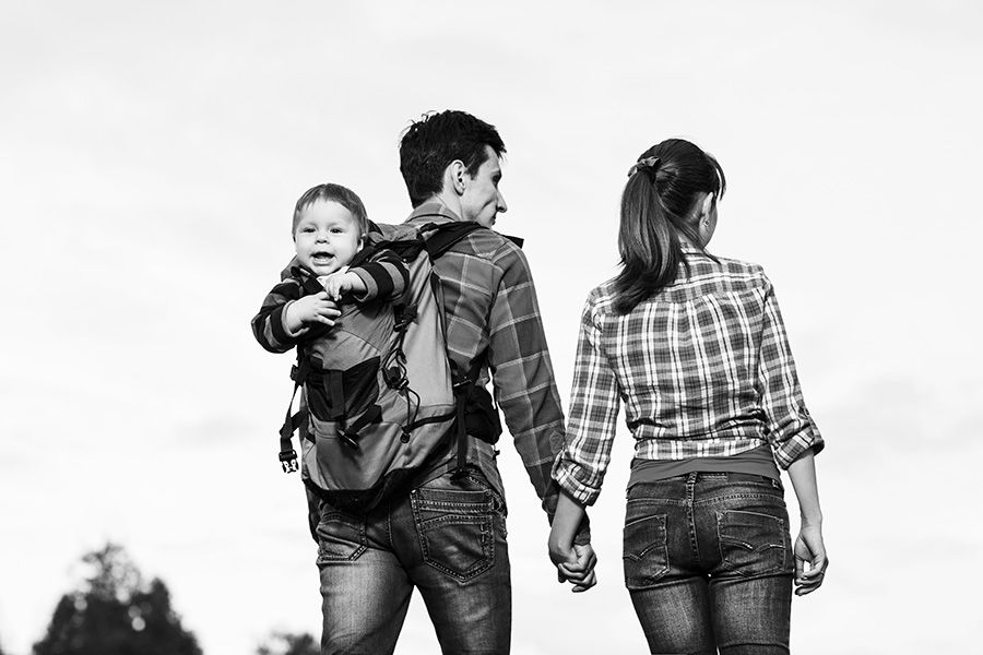 Family traveling through airport with children and luggage