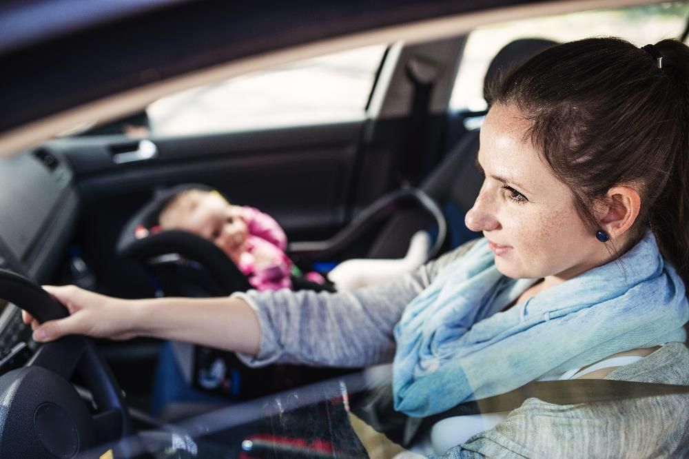 Teenager properly seated in front seat with seat belt